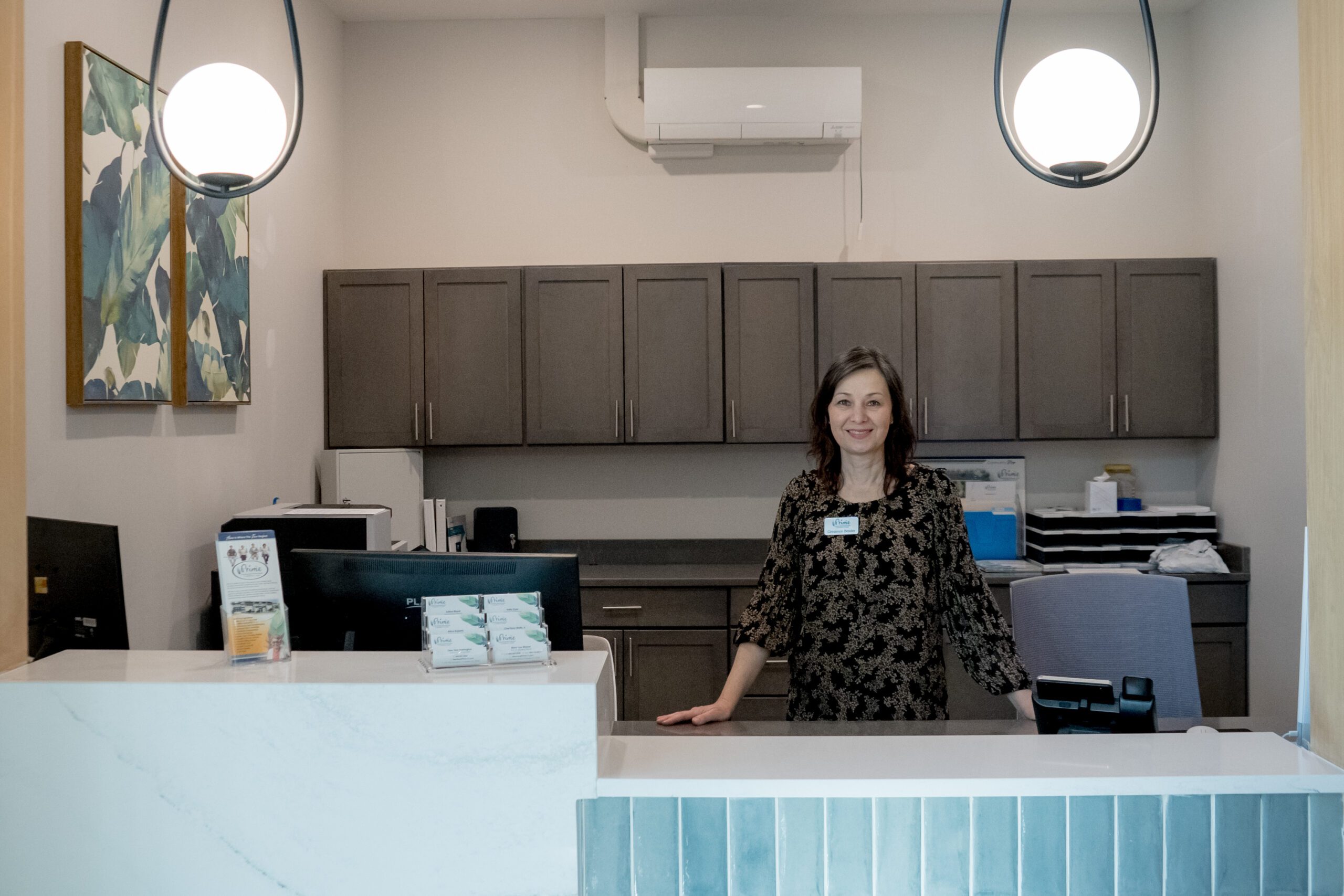 A member of Prime Carolina Coast's friendly team waits to provide service at the front desk.
